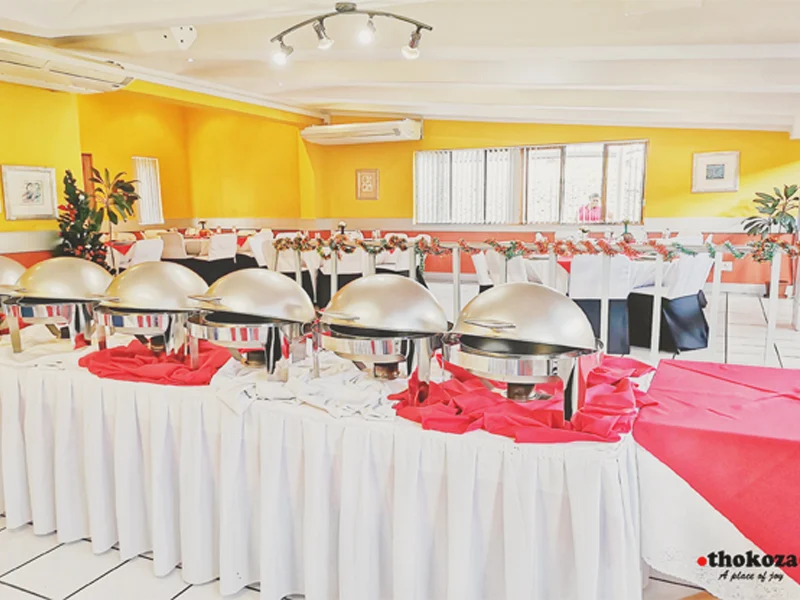 Banquet hall set with chafing dishes and decorated tables