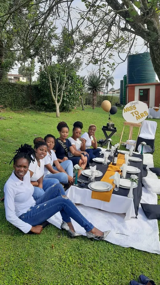 Guests gathered on a picnic blanket in the Thokoza gardens